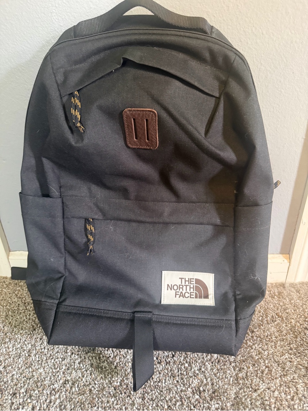 The North Face Black Backpack with Brown Patch
